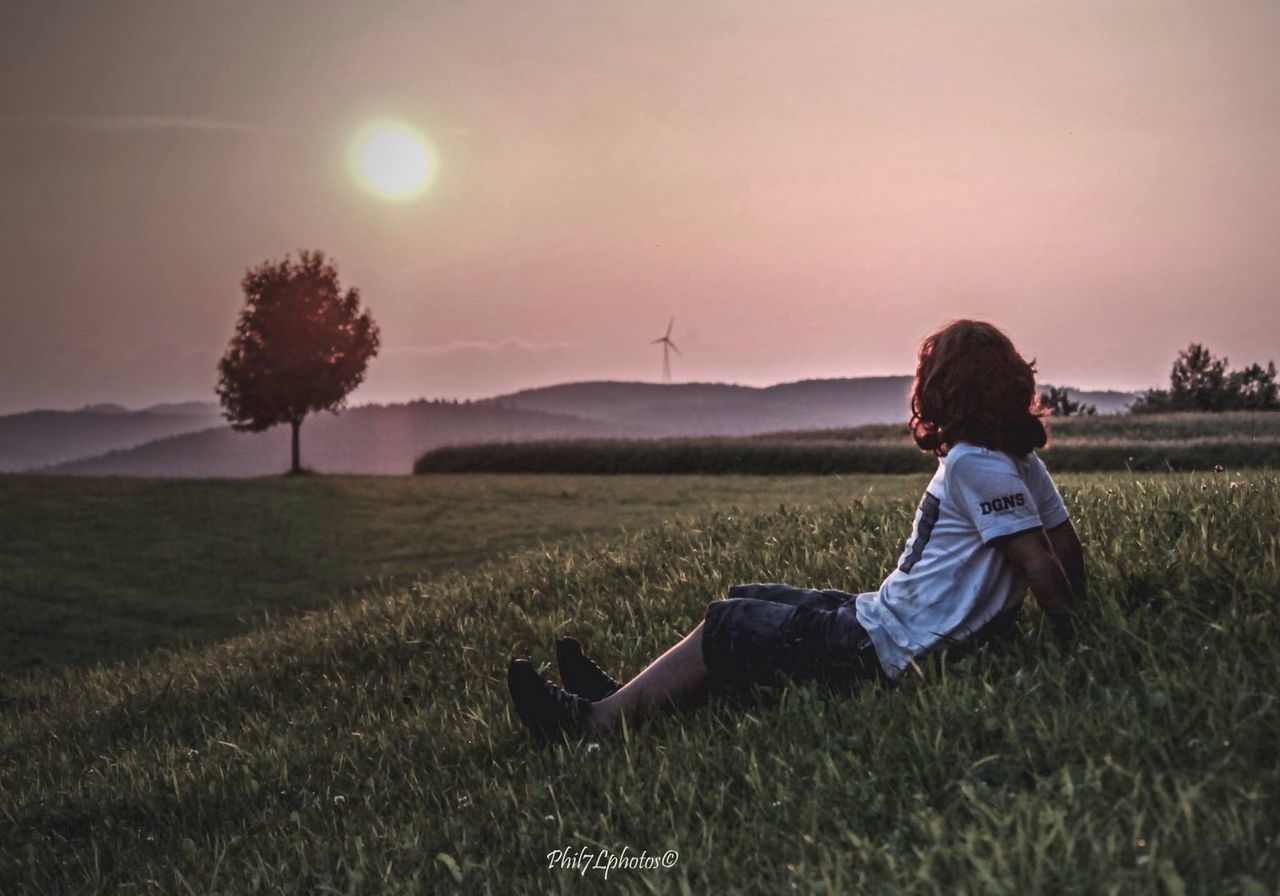 lifestyles, leisure activity, casual clothing, rear view, men, full length, field, person, standing, tree, holding, landscape, three quarter length, nature, sky, tranquil scene, childhood