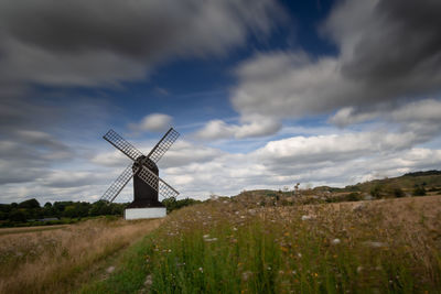 Windmill on field against sky