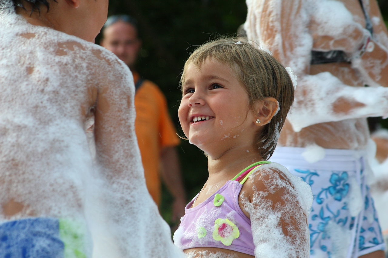 childhood, girls, real people, elementary age, family, leisure activity, togetherness, lifestyles, boys, love, happiness, day, outdoors, water, smiling, animal themes, nature, close-up, mammal