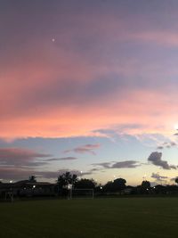 Scenic view of field against sky at sunset