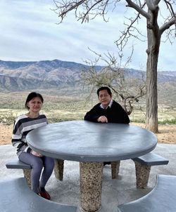 Portrait of senior couple sitting against mountain