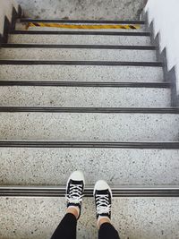 Low section of person standing on staircase