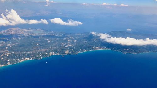 Aerial view of sea and mountains against sky