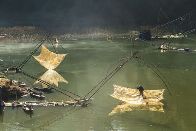 Man fishing with chinese fishing nets in lake