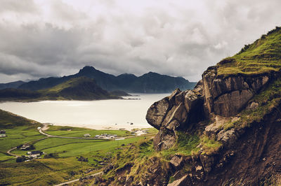 Scenic view of sea and mountains against sky