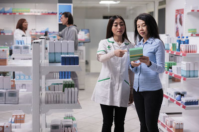 Portrait of smiling young woman standing in factory