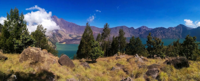 Panoramic view of mountains against blue sky