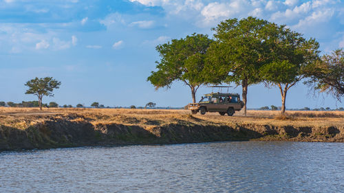 Scenic view of a safari motor vehicle in the wilderness 