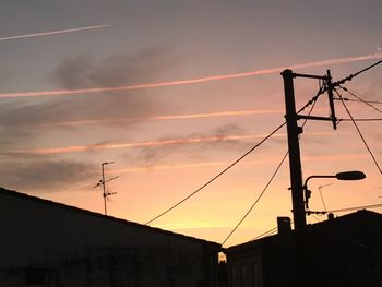 Low angle view of electricity pylon against sky