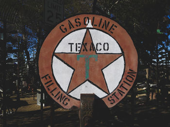 Close-up of road sign against trees