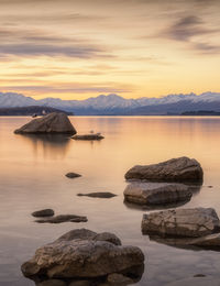 Scenic view of lake against sky during sunset