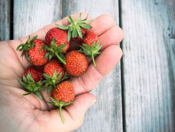 Close-up of hand holding strawberries