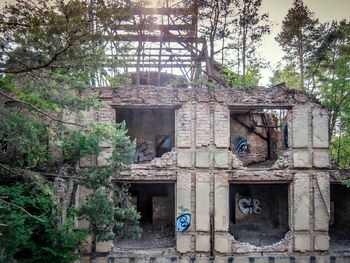 Abandoned building against trees