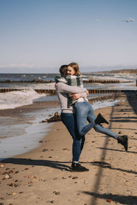 Full length of young couple on beach