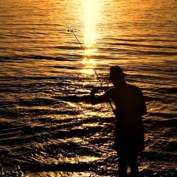 Silhouette of people at sunset