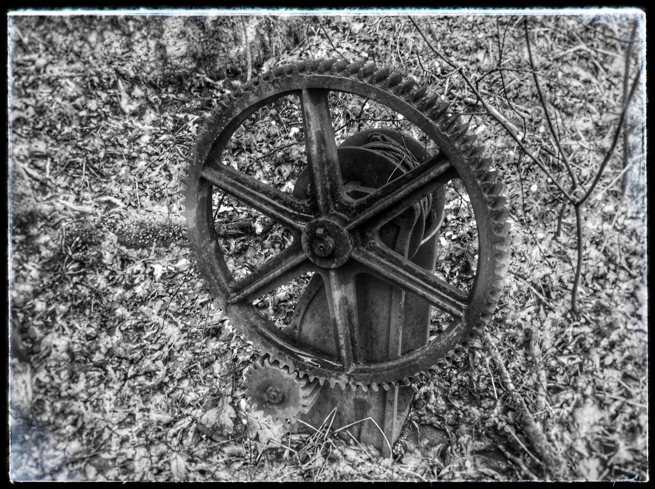 transfer print, auto post production filter, metal, wheel, circle, close-up, metallic, no people, old, day, pattern, abandoned, outdoors, rusty, design, nature, built structure, wall - building feature, textured, geometric shape