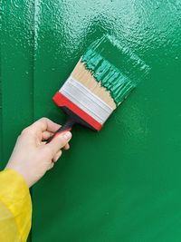 Cropped hand of person cleaning brush