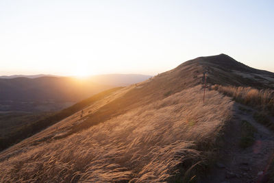 Scenic view of mountains against clear sky during sunset