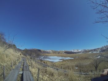 Panoramic view of landscape against clear blue sky