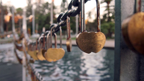 Close-up of padlocks hanging on rusty chain