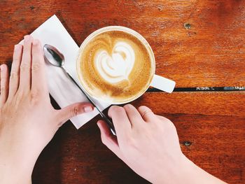 Midsection of woman holding coffee cup