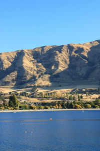 Scenic view of mountains against clear blue sky