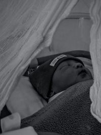 Portrait of young woman sleeping in bed