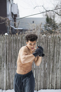 Young male boxer posing in the snow