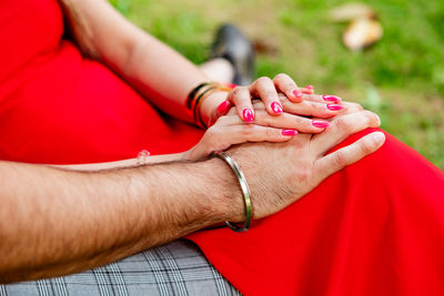 Midsection of woman holding hands
