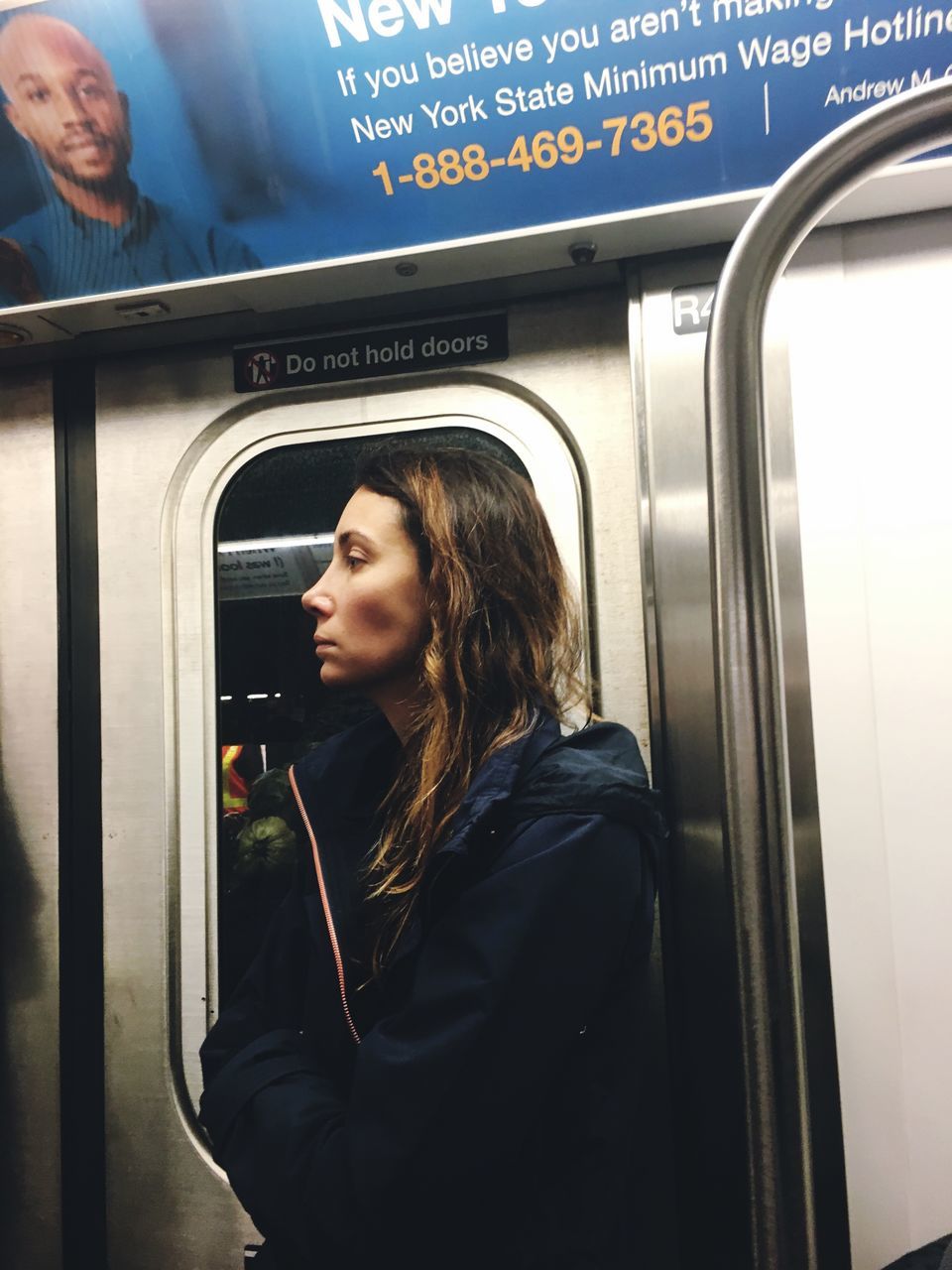 public transportation, train - vehicle, real people, casual clothing, passenger, transportation, standing, lifestyles, one person, side view, subway train, leisure activity, indoors, technology, young adult, day, young women, vending machine, adult, people