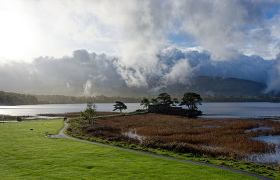 Low clouds above mccarthy mor castle in killarney national park, kerry, ireland