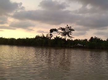 Scenic view of lake against sky at sunset