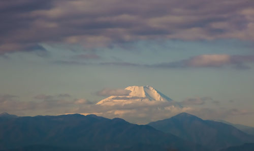 Scenic view of mountains against sky at sunset