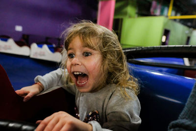 Little girl screaming on amusement park ride