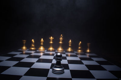 Close-up of chess board against black background