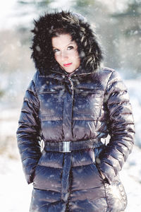 Portrait of woman standing in snow