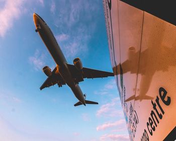 Low angle view of airplane against sky