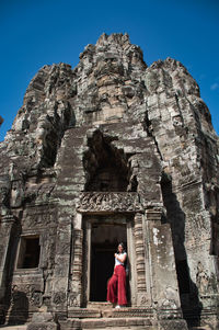 Full length of man at temple against sky