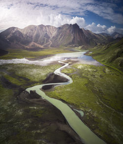 Scenic view of river amidst mountains against sky