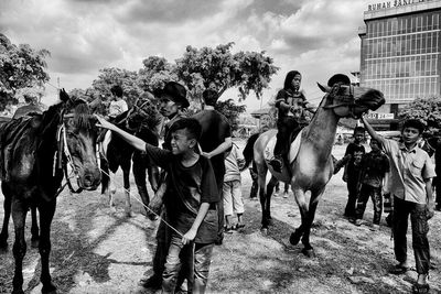 Panoramic view of people on street against sky