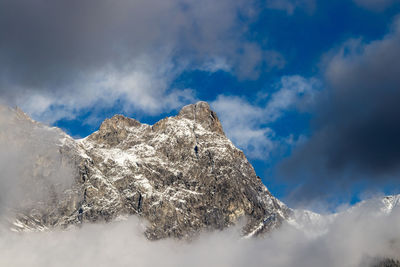 Low angle view of snowcapped mountain against sky