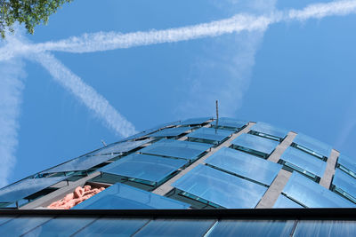 Low angle view of modern building against blue sky