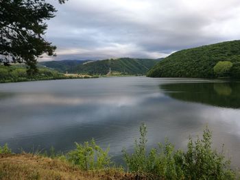 Scenic view of lake against cloudy sky