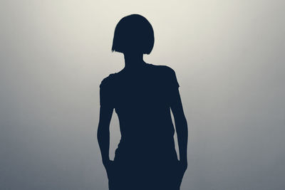 Silhouette woman standing against clear sky