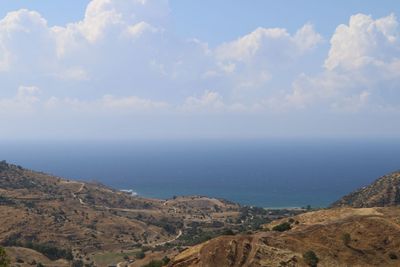 Scenic view of sea and mountains against sky