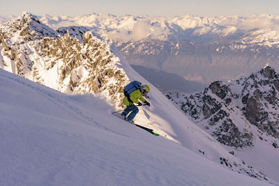 Man skiing on snowcapped mountains