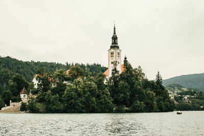 Scenic view of trees and buildings against sky