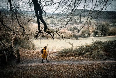 Young blonde woman walking in the forest.