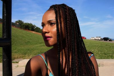 Portrait of beautiful woman on land against sky