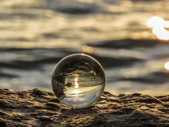 Close-up of crystal ball on rock